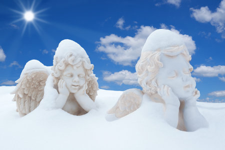 Two snowy angels in the sunshineの写真素材