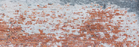Panorama of a very old and crooked brick wallの写真素材