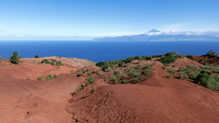 La Gomera, Canary Islands - erosion landscape with red soil on the north coast above Agulo with a view to Tenerifeの写真素材