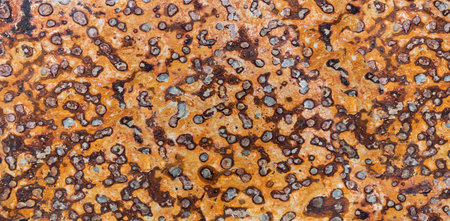 Orange brown slate stone slab with abstract dotted pattern in close-up