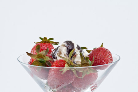 Strawberrys with creme and chocolate isolated on white backgroundの写真素材