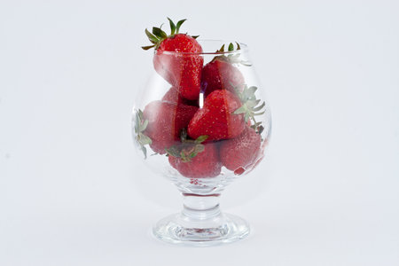Strawberrys in a cup isolated on white backgroundの写真素材