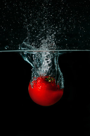 Fresh tomato in waterの写真素材