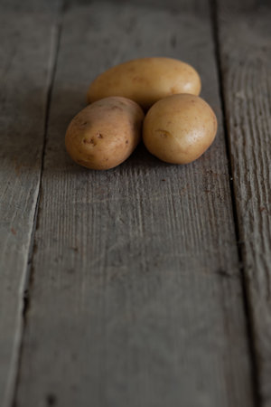 Fresh potato on a wooden boardの写真素材