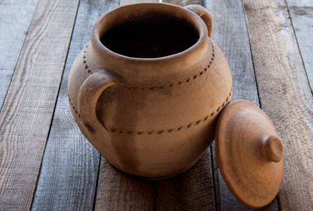 Old rustic crock on a wooden tableの写真素材