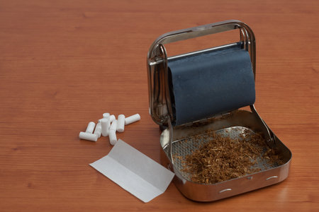 Metal rolling machine with some filters for cigarette isolated on white backgroundの写真素材