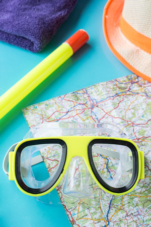 sport, fitness, water sports and objects concept - close up of swimming goggles and towelの写真素材