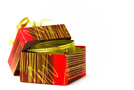 Red open gift box on white background with golden bow