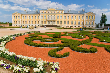 Yellow baroque palace with garden in foregroundの写真素材