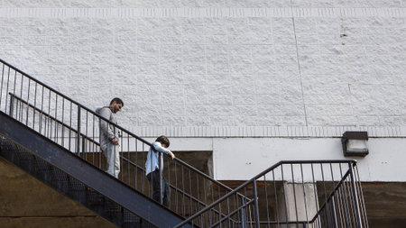 Man and Boy Descending Staircaseの写真素材