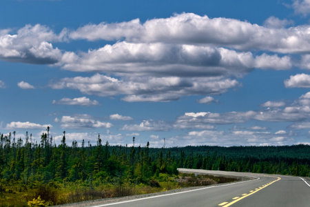 Driving Toward a Cloudy Blue Skyの写真素材