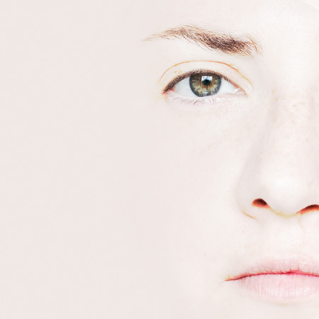 Closeup Portrait of Woman with Green Eyes Showing Half Faceの写真素材