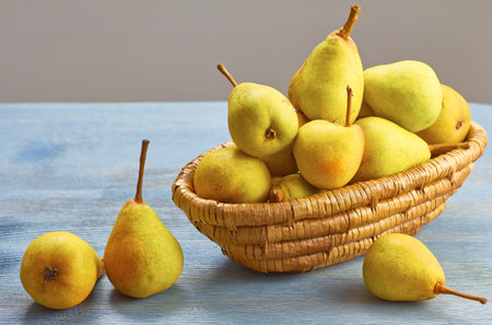 Fresh organic pears in basket on wooden table