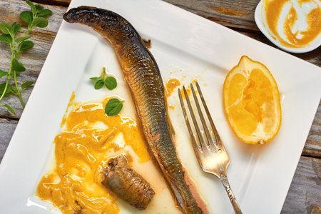 Stewed lamprey  with mustard and lemon on plateの写真素材