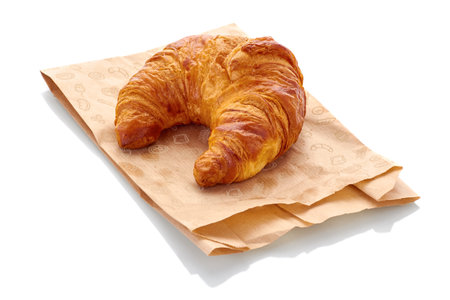 fresh croissant with paper bag isolated on white backgroundの写真素材