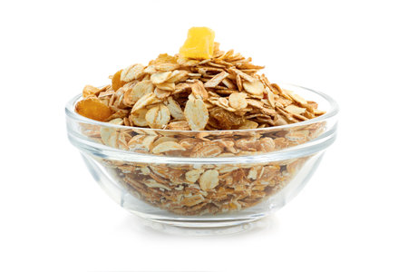 Muesli breakfast in glass  bowl isolated on white backgroundの写真素材