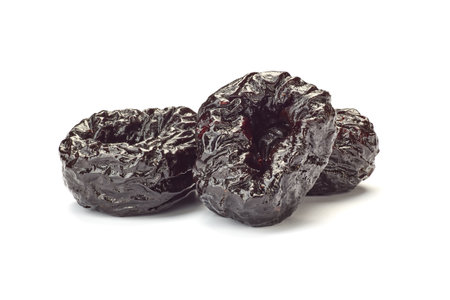Three dried plums on whiteの写真素材
