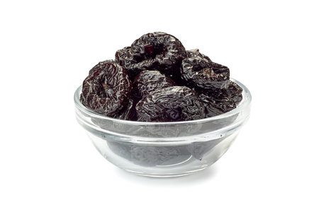 Bowl of dried plums on whiteの写真素材