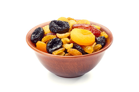Bowl of dried fruits mix on whiteの写真素材