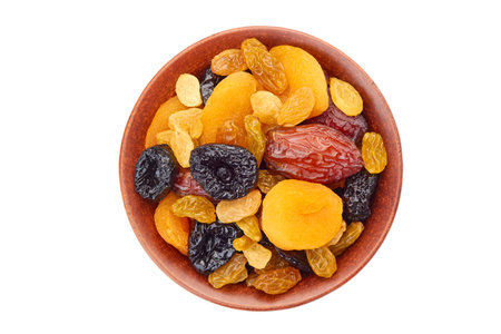Bowl of dried fruits mix on whiteの写真素材