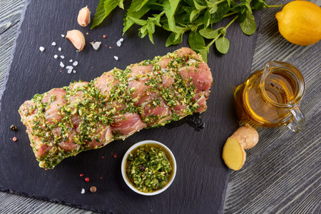 Raw pork loin with spices ready for bakingの写真素材