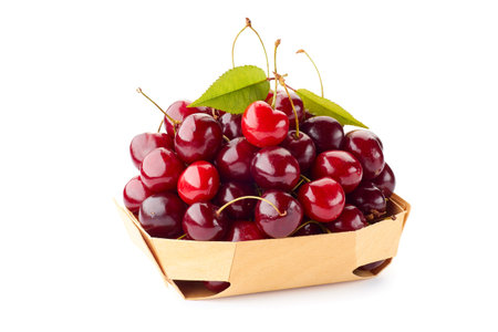 Heap of ripe cherries on wooden retail tray