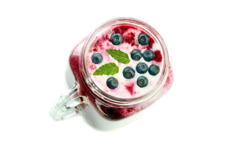 Jar of blueberry smoothie on whiteの写真素材