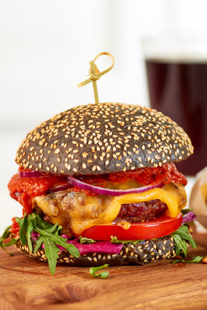 Black cheeseburger on wooden boardの写真素材