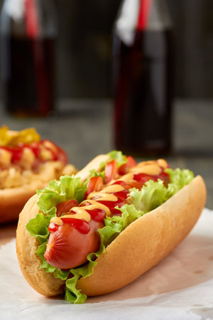 Hot dog with lettuce and tomatoの写真素材
