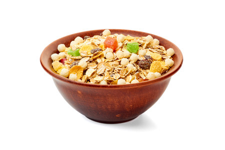 Bowl of muesli with dried exotic fruits on whiteの写真素材