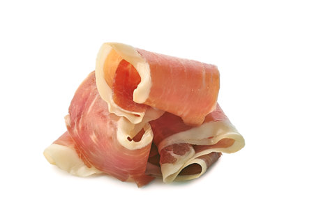 Sliced jamon of ham folded on whiteの写真素材