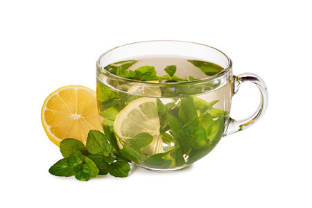 Glass teacup with herbal tea and lemon on white backgroundの写真素材