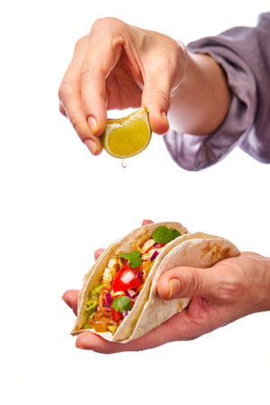 A Truly Delicious Taco That Is Being Generously Topped with Fresh Lime Juice for Flavorの写真素材
