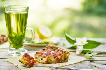 Enjoy a Refreshing Green Tea paired with a Savory Snack while surrounded by Natures beautyの写真素材