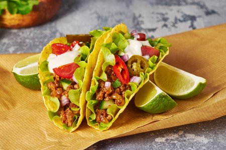 Indulge in Delicious Tacos Made with Fresh Ingredients and Garnished with Lime Slicesの写真素材