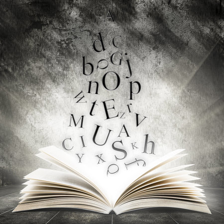 Old open book with magic light and falling letters on a dark abstract background