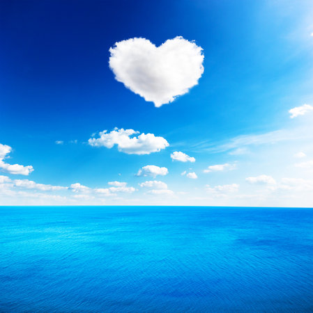 Blue sea under clouds sky with heart shape cloud backgroundの写真素材