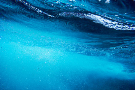 Sea bottom with blue water wave splash background