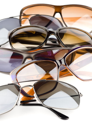 Collection of assorted styles of tinted sunglasses on white backgroundの写真素材