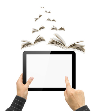 Black tablet pc like touch pad in hands and book on white .Portable computer education conceptの写真素材