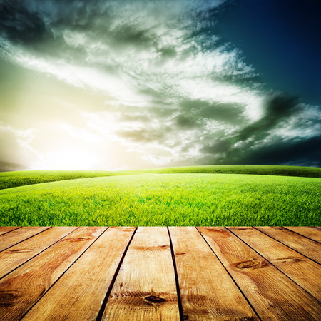 Wood floor texture over green field under blue skyの写真素材