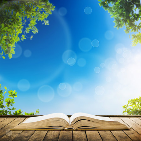 Open book on wood planks over sky with leaves backgroundの写真素材
