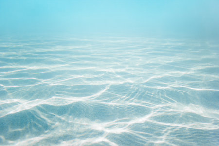 Sandy sea bottom with blue water backgroundの写真素材