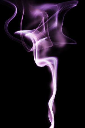 Abstract color smoke swirls over black backgroundの写真素材