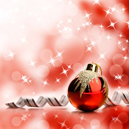 Red christmas toy over abstract bright yellow backgroundの写真素材