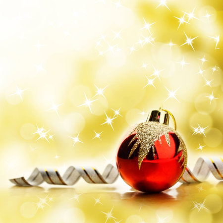 Red christmas toy over abstract bright yellow backgroundの写真素材