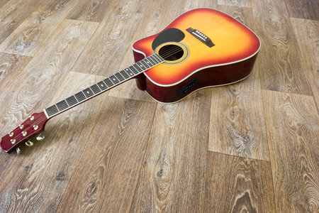 Guiiar in blank empty room with wooden floor backgroundの写真素材