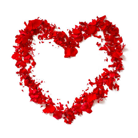 Heart shape out of red rose petals over white backgroundの写真素材