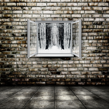 Open window from old room with winter forest on a backgroundの写真素材