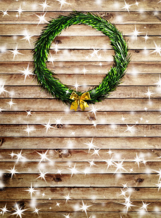 Christmas wreath with snow and stars on the wood backgroundの写真素材